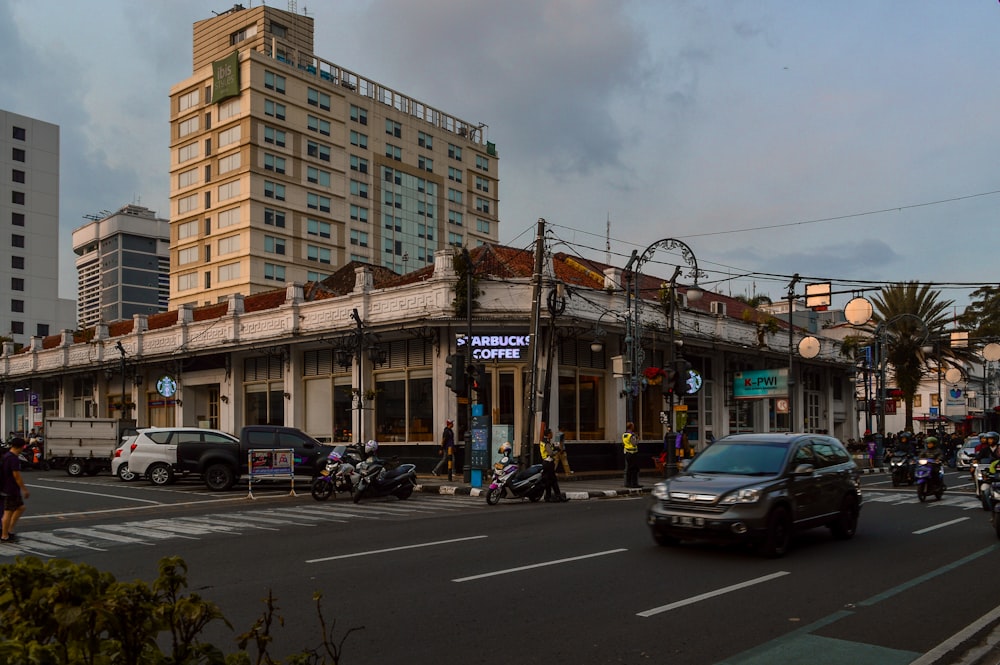 a busy city street with cars and motorcycles