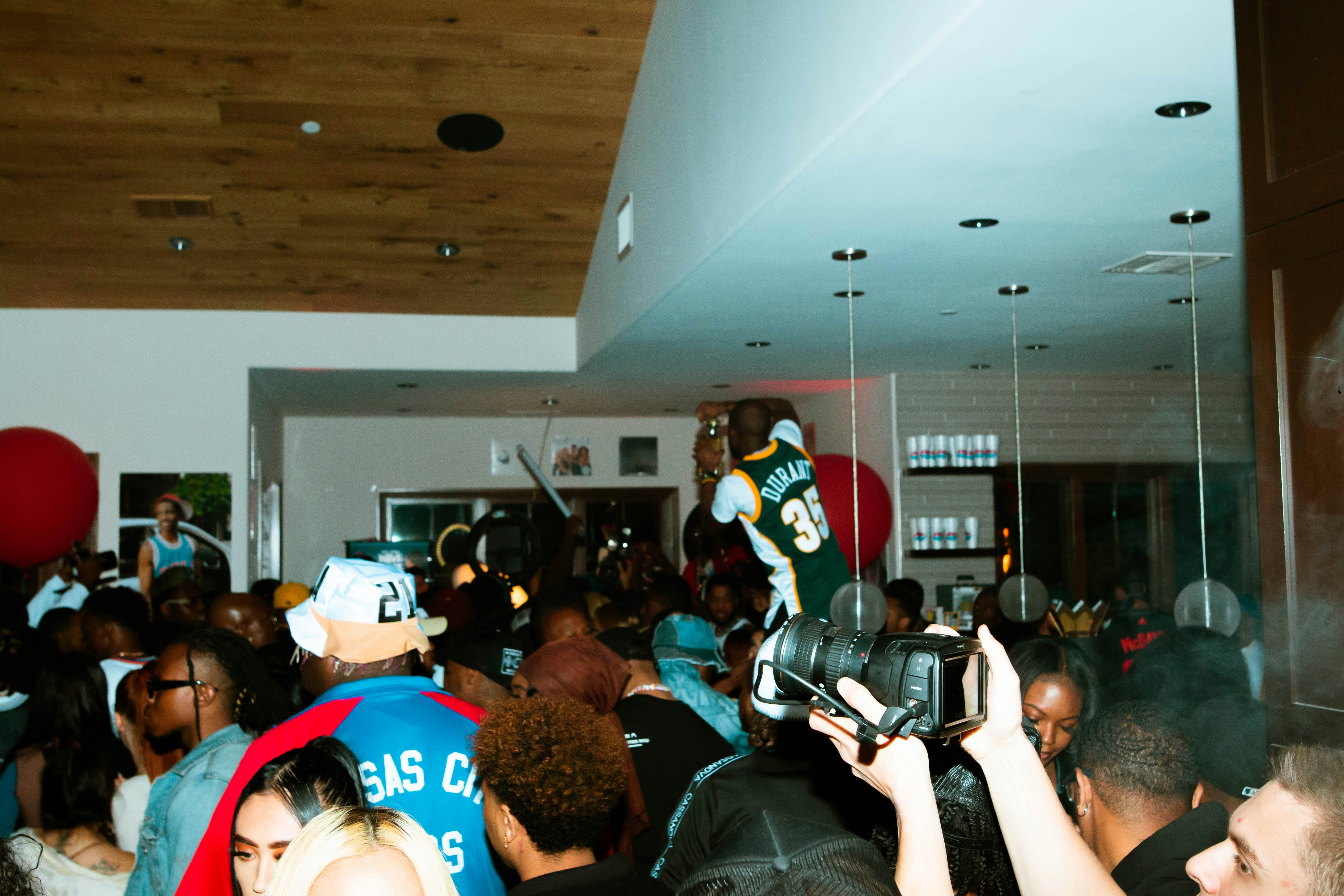 a crowd of people standing around each other