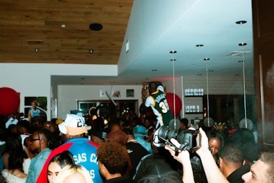 a crowd of people standing around each other