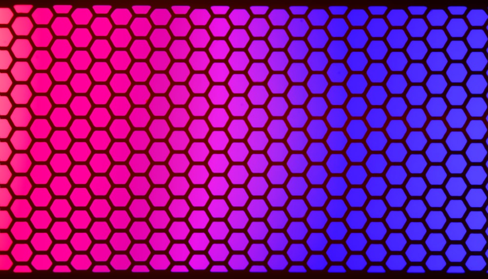 a purple and pink background with hexagonal shapes