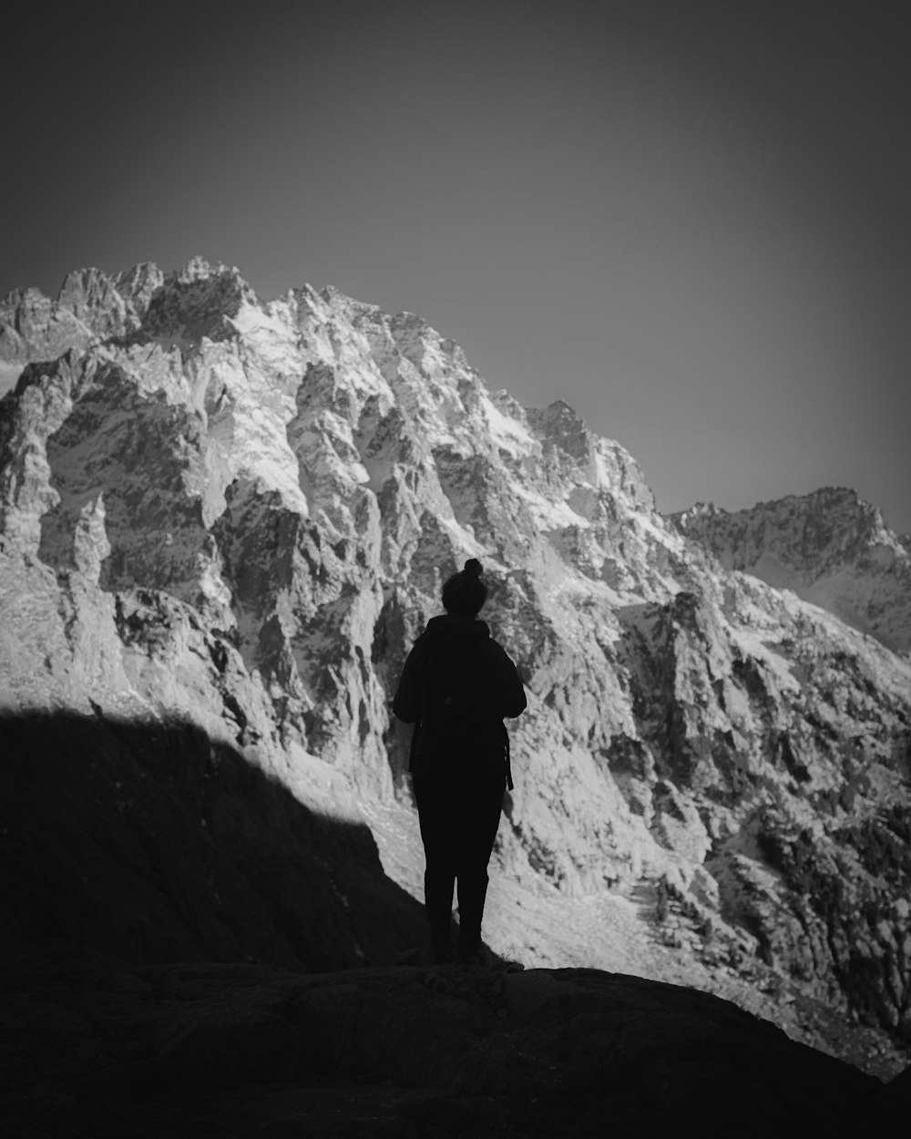 a person standing on top of a snow covered mountain