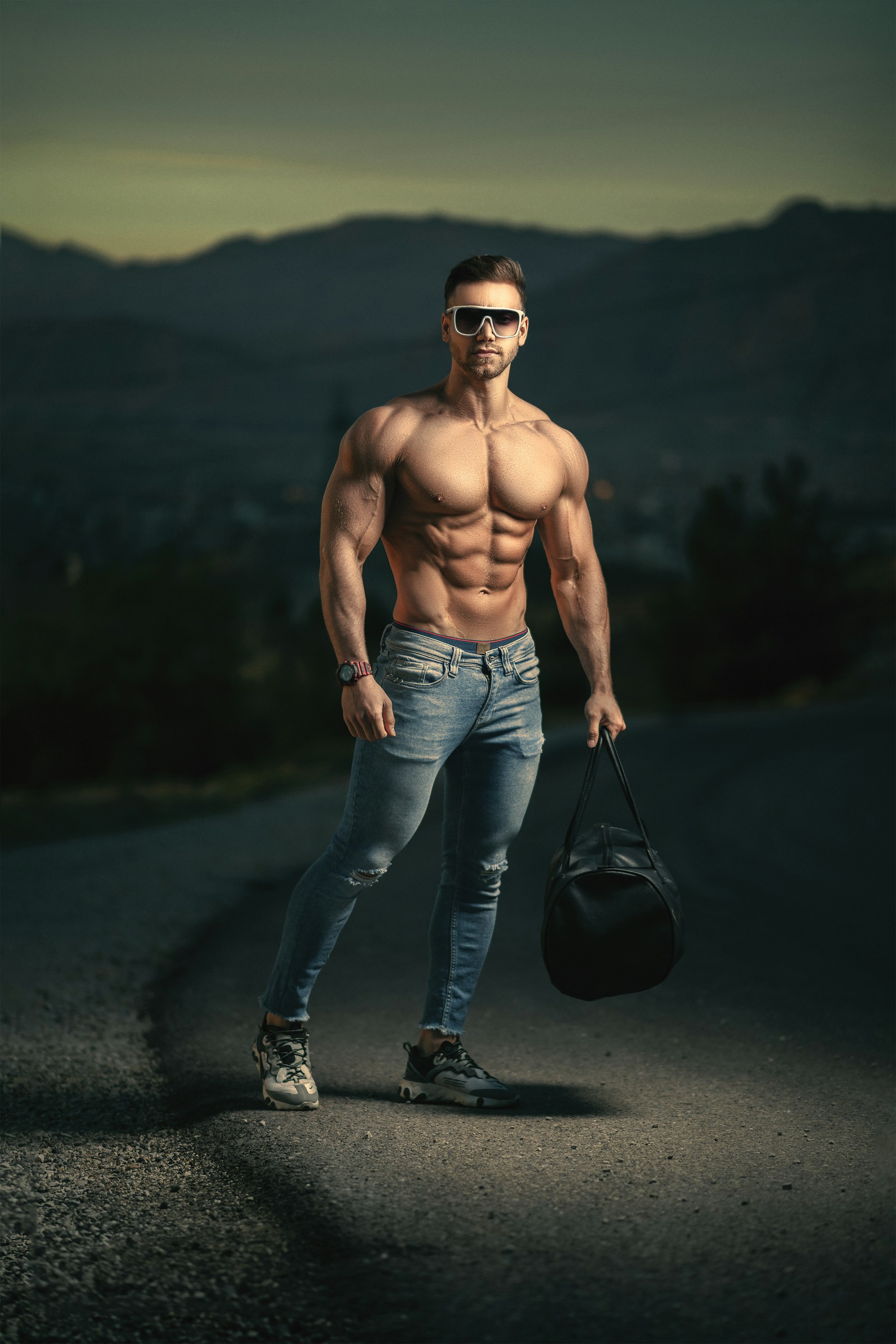 a shirtless man with no shirt holding a bag