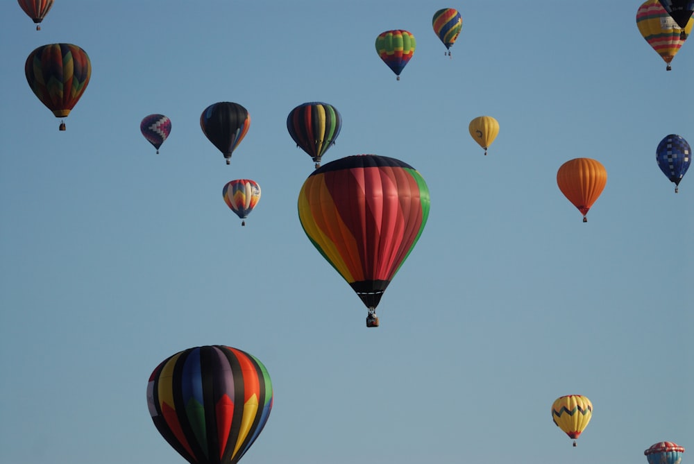 a bunch of hot air balloons flying in the sky