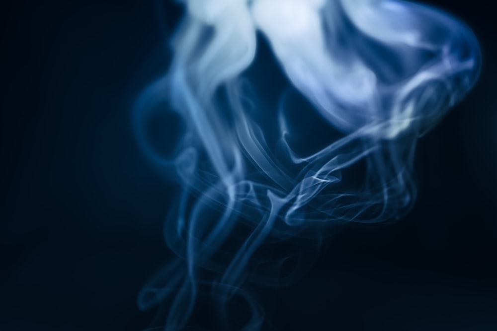 a blurry photo of smoke on a black background