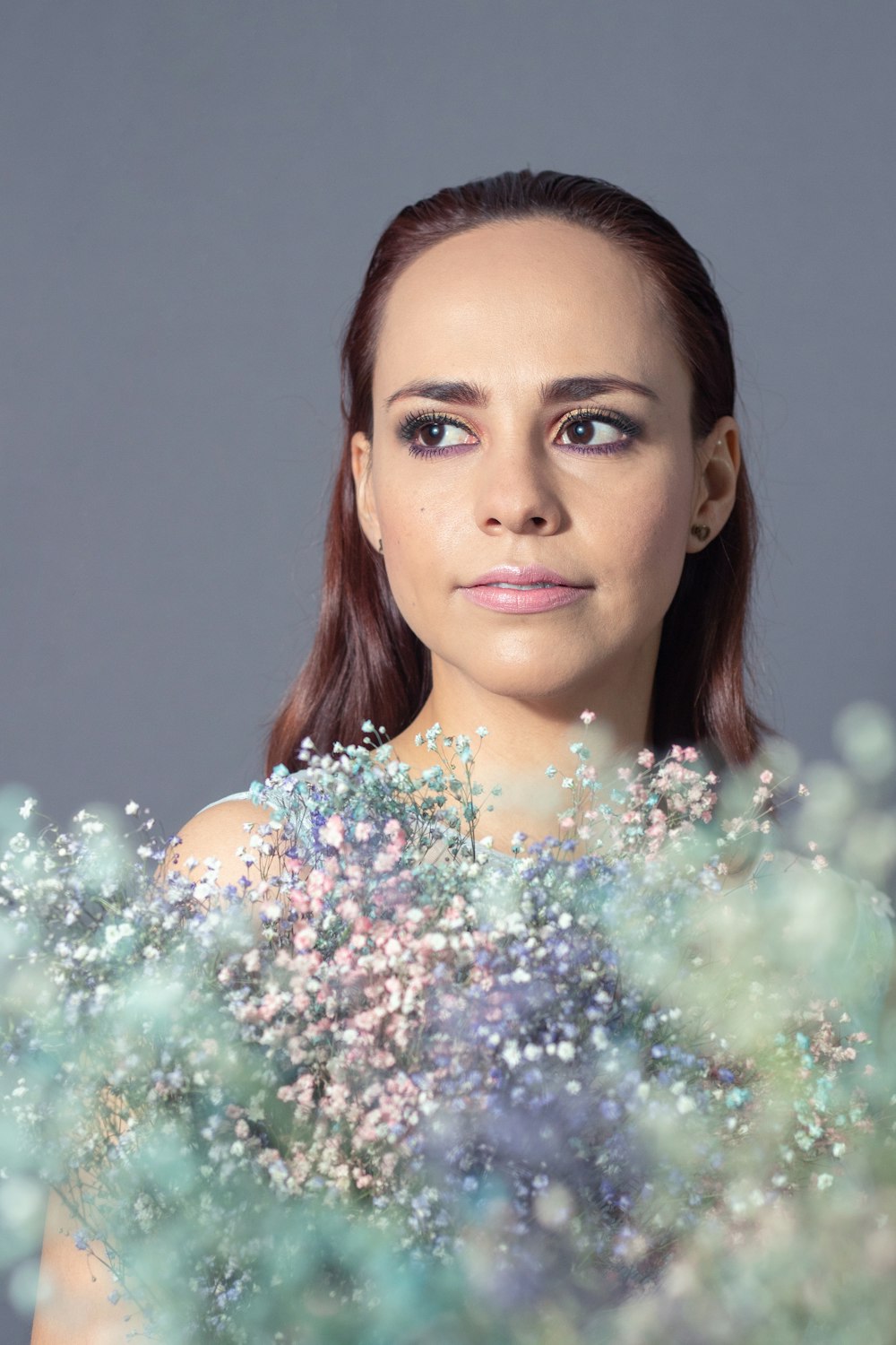 a woman is holding a bouquet of flowers