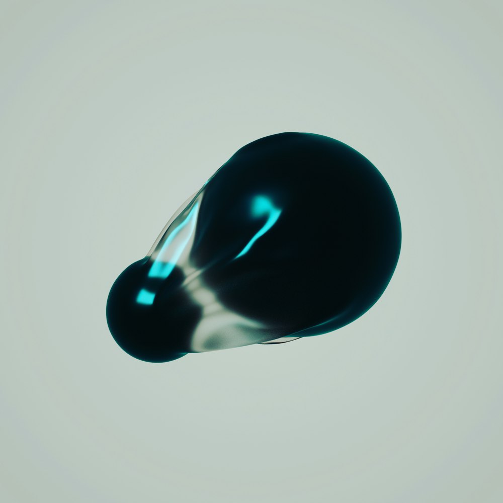 a black object floating in the air on a gray background