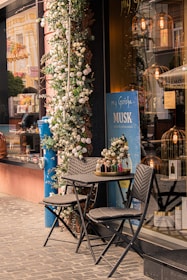 two chairs and a table outside of a store