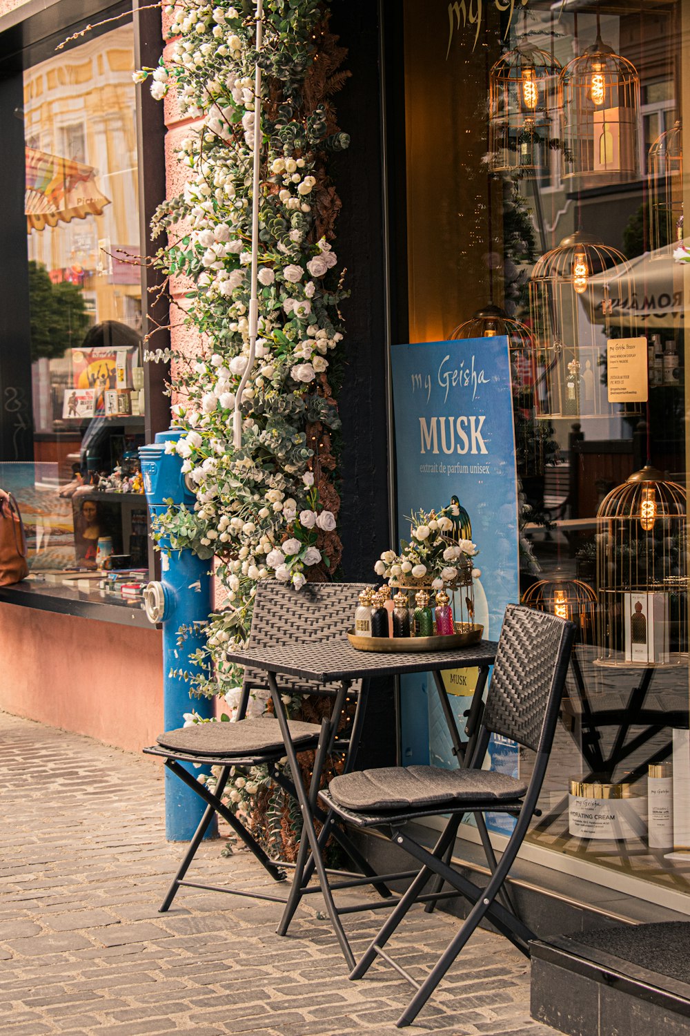 two chairs and a table outside of a store