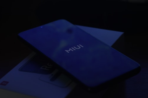 a close up of a cell phone near a credit card