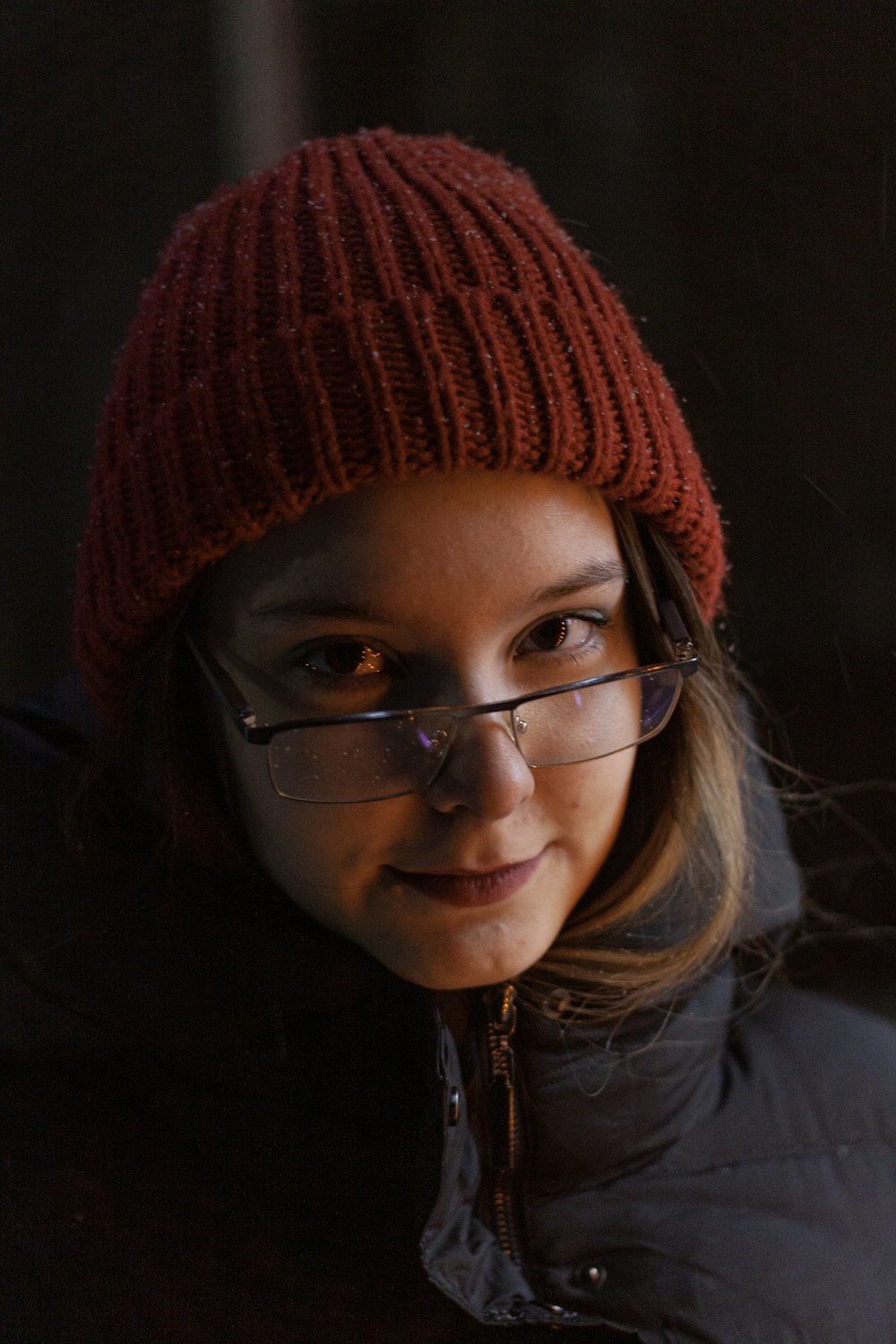 a girl wearing glasses and a knitted hat