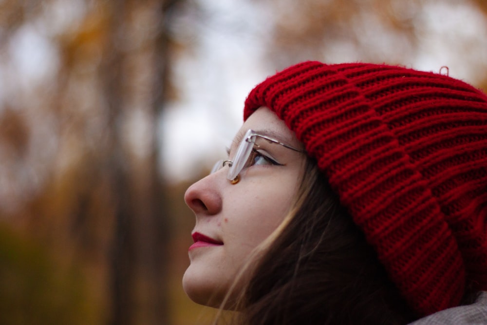 a woman wearing glasses and a red hat