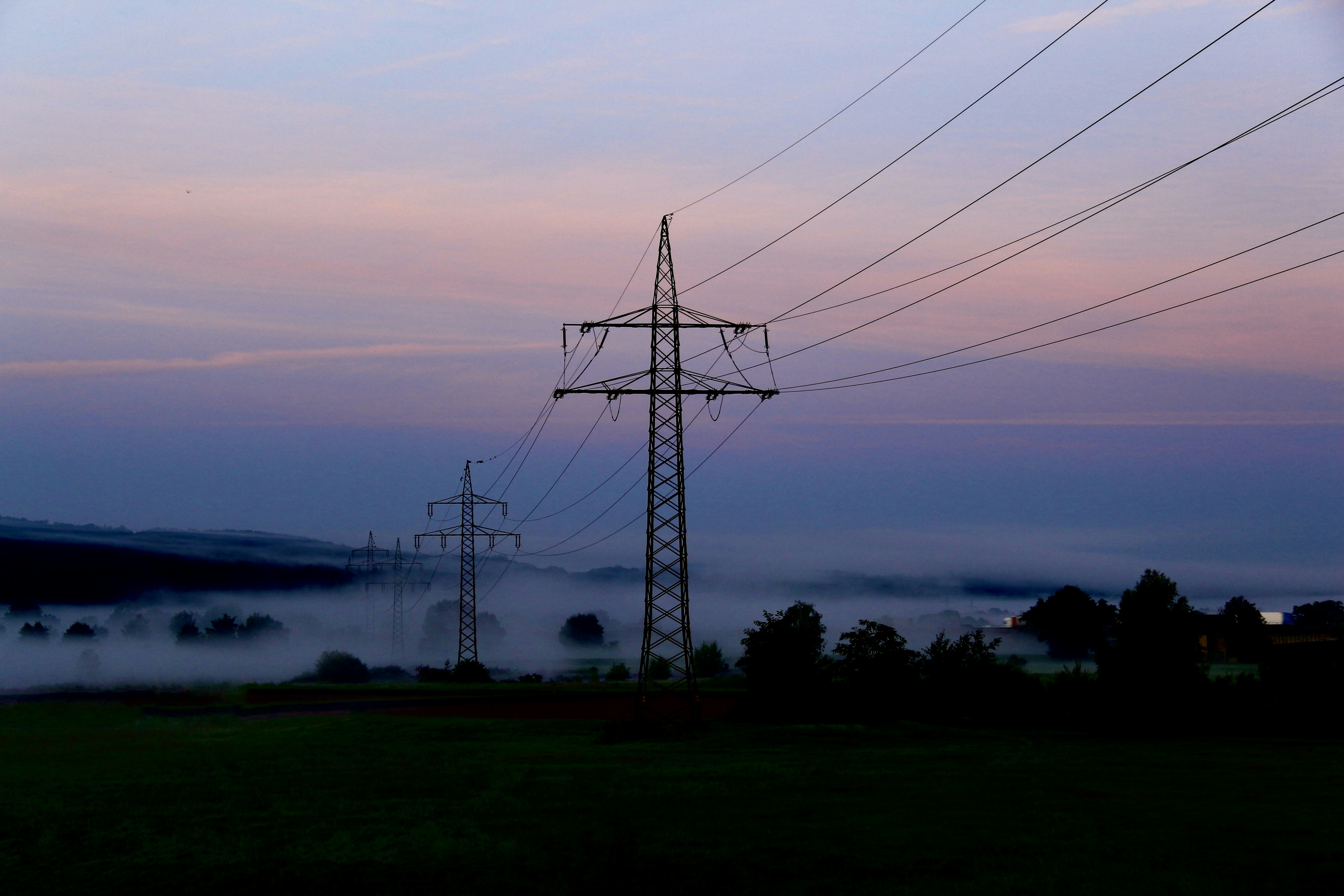 a power line with fog in the background