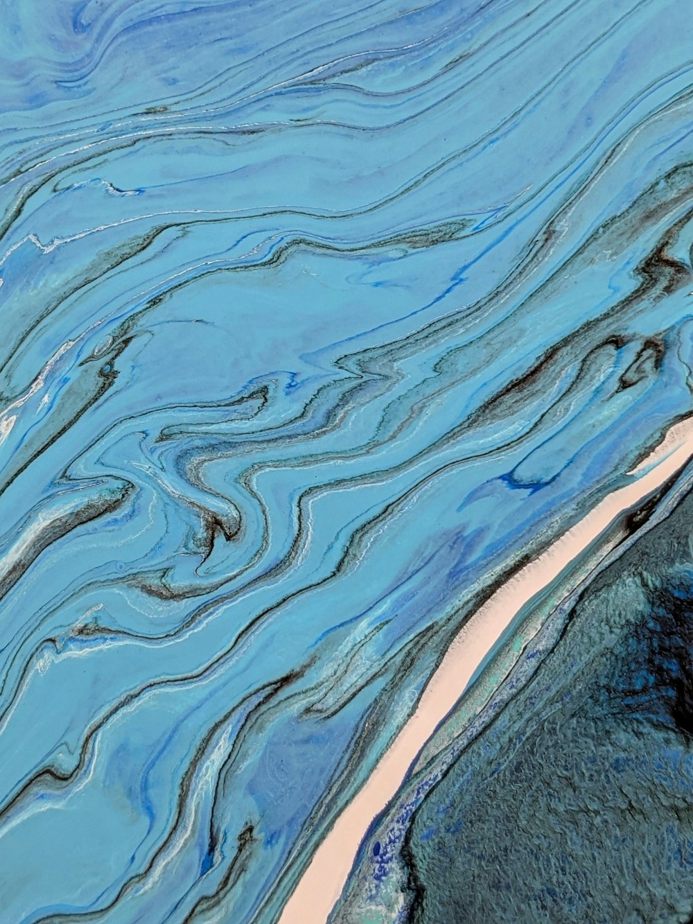 a close up of a water surface with blue and white colors