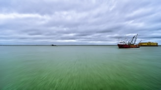 a large boat floating on top of a large body of water