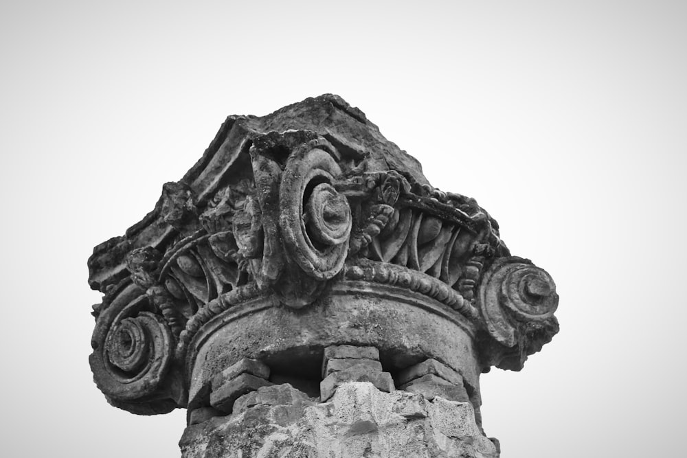 a black and white photo of a stone column