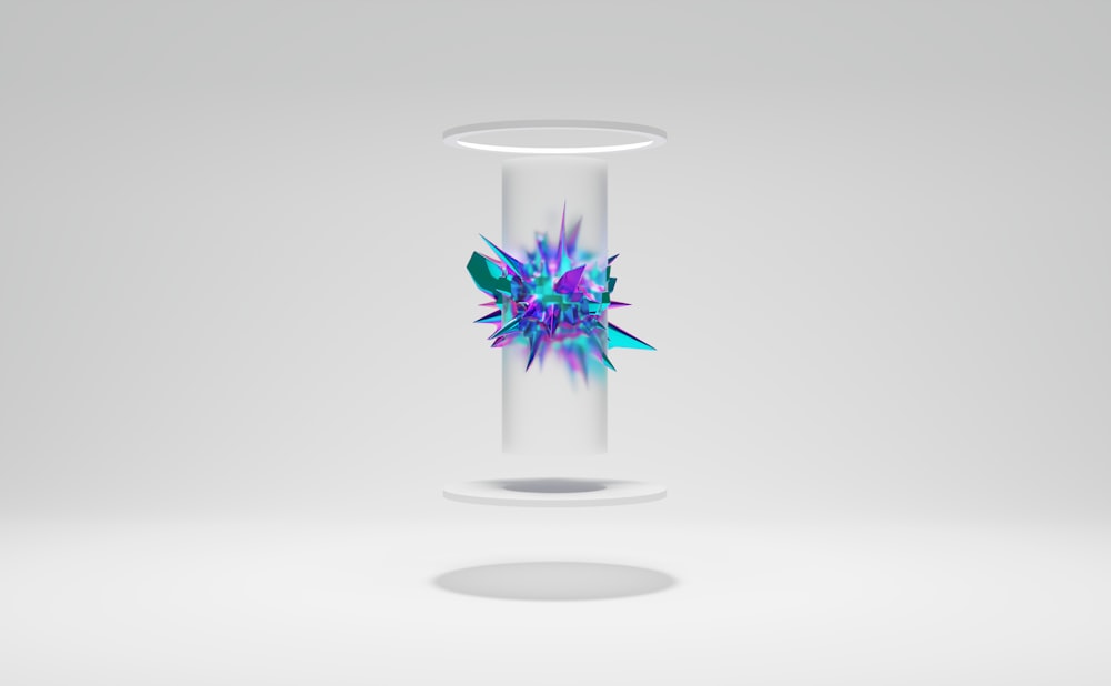 a glass vase with a blue and purple flower in it