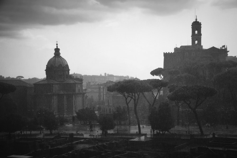 a black and white photo of a city with a clock tower