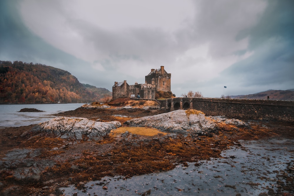 a castle sitting on top of a rocky shore