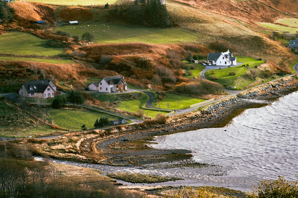 a scenic view of a small village on the shore of a body of water