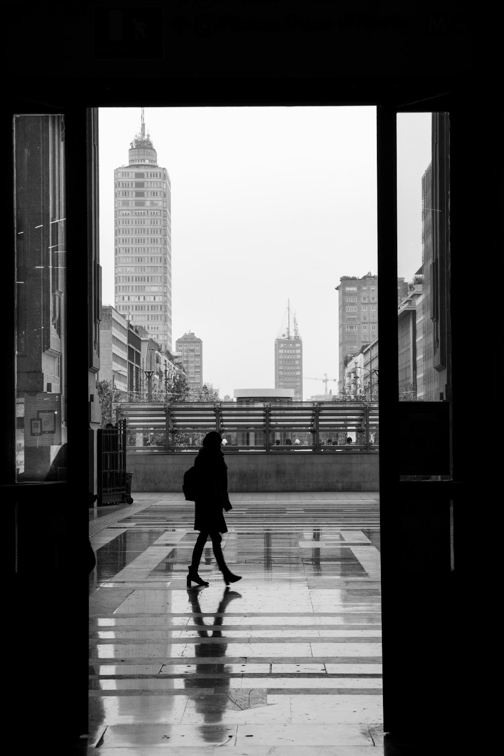 a person walking down a walkway in the rain