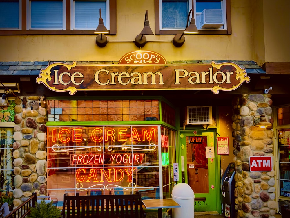 an ice cream parlor with a wooden bench in front of it
