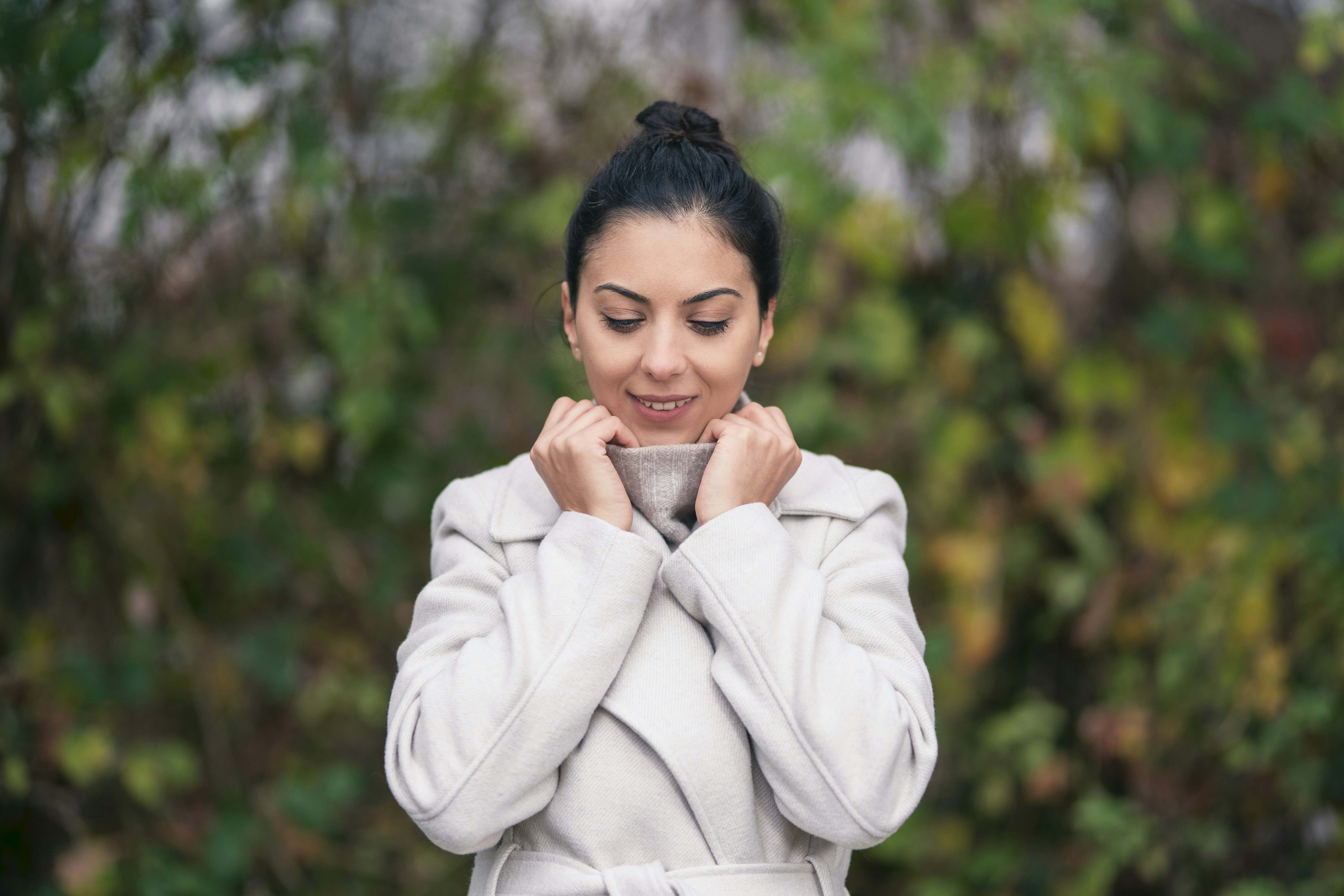 a woman in a bathrobe holding a cup of coffee