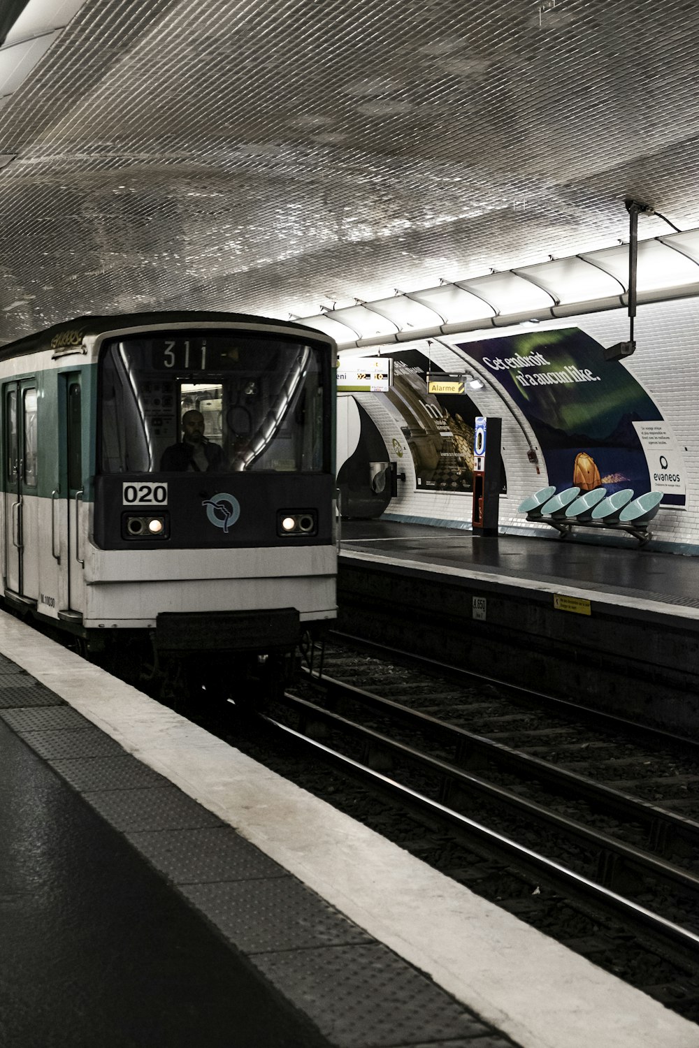 a train pulling into a train station next to a platform