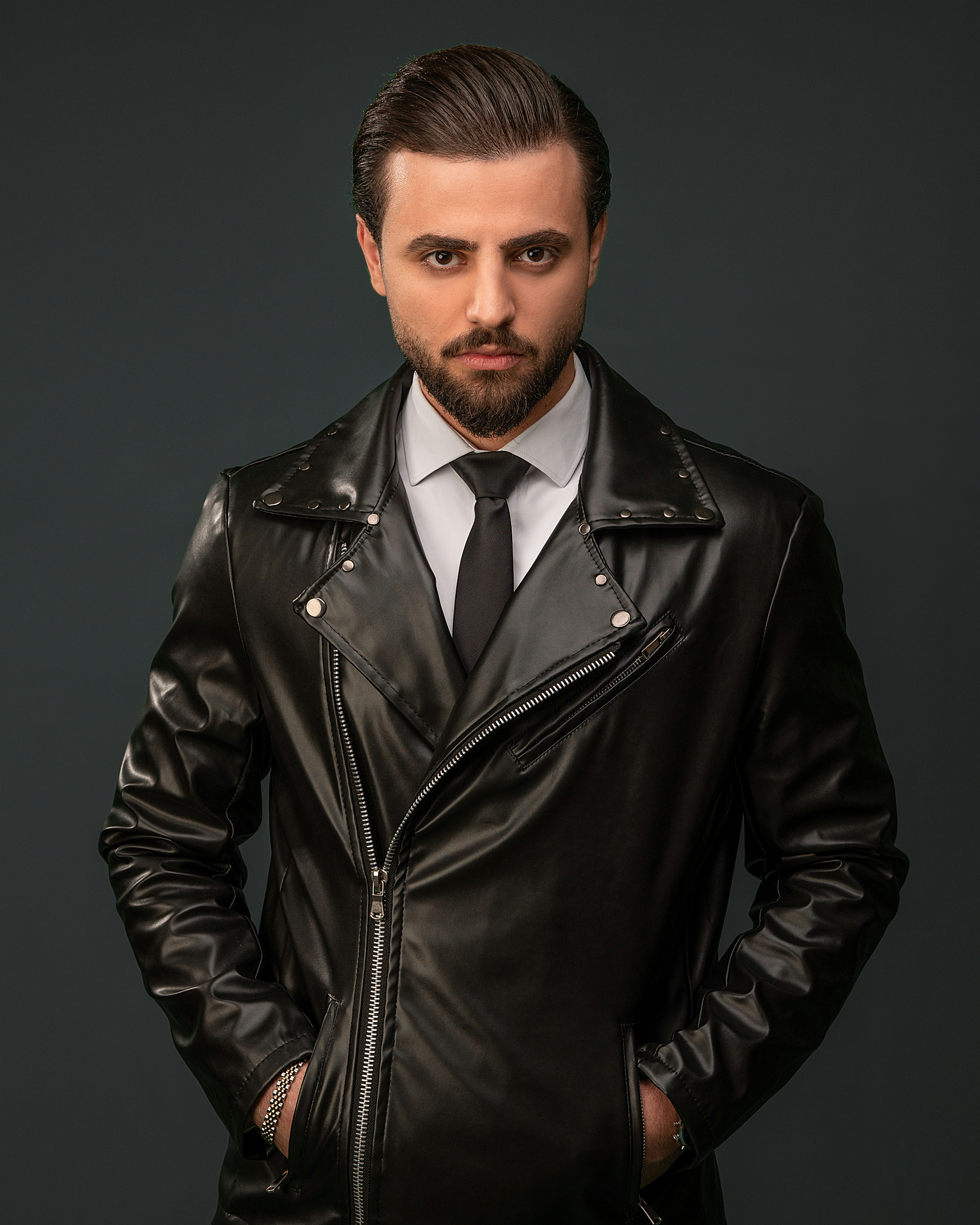 A man wearing a black leather jacket and tie photo Free Clothing