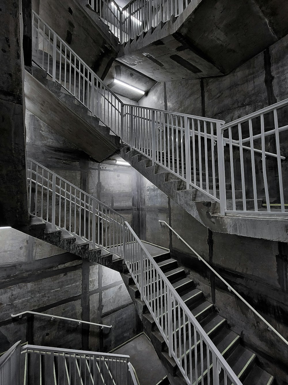 a black and white photo of a spiral staircase