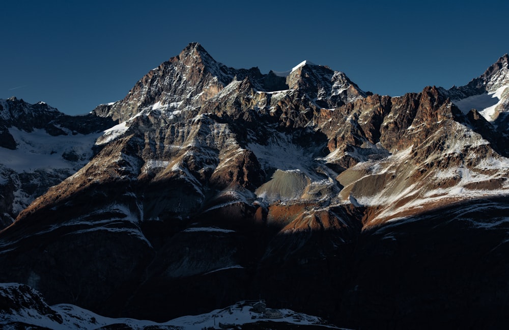 a view of a mountain range with snow on it