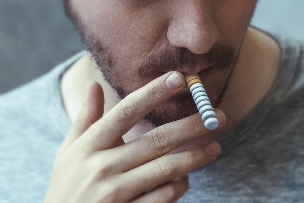 a man with a cigarette in his mouth