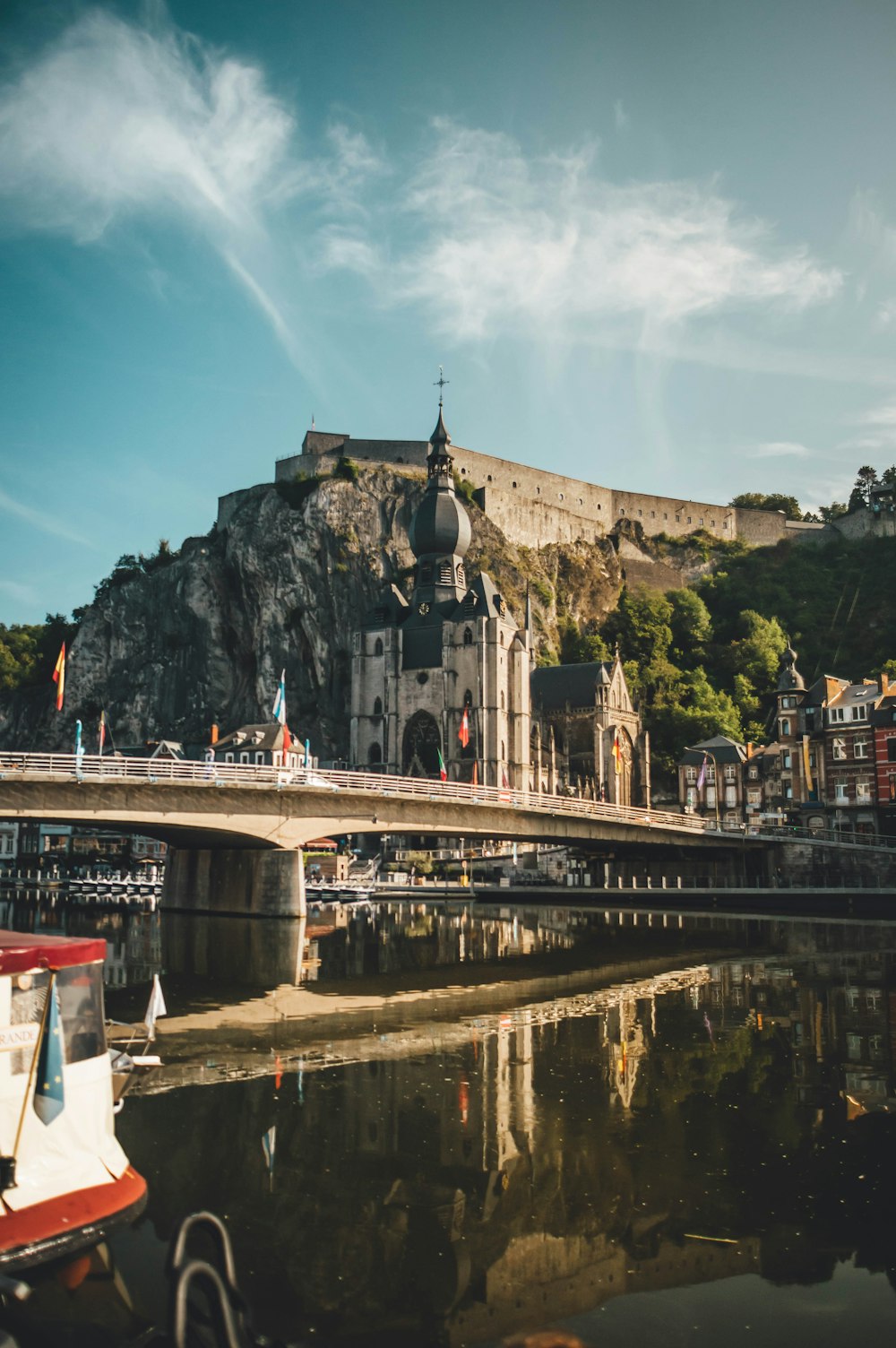 a bridge over a body of water with a castle in the background