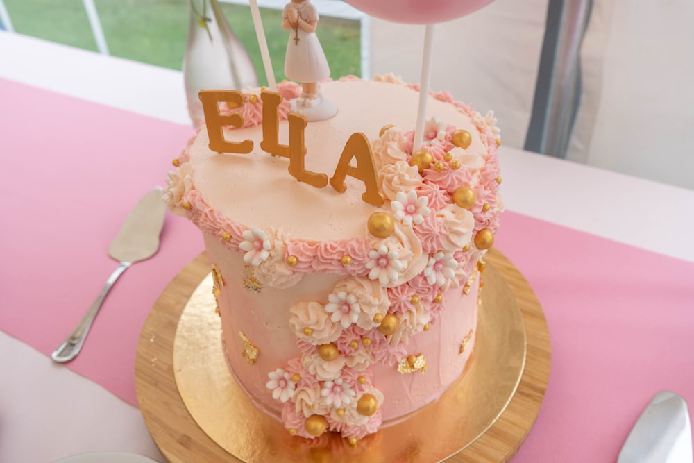 a pink and gold cake on a gold plate