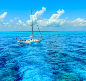 a sailboat in the middle of the ocean