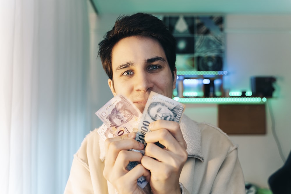 a woman holding a bunch of money in her hands