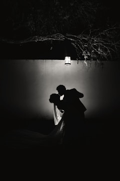 A softly lit portrait of a couple sharing a quiet moment outdoors.