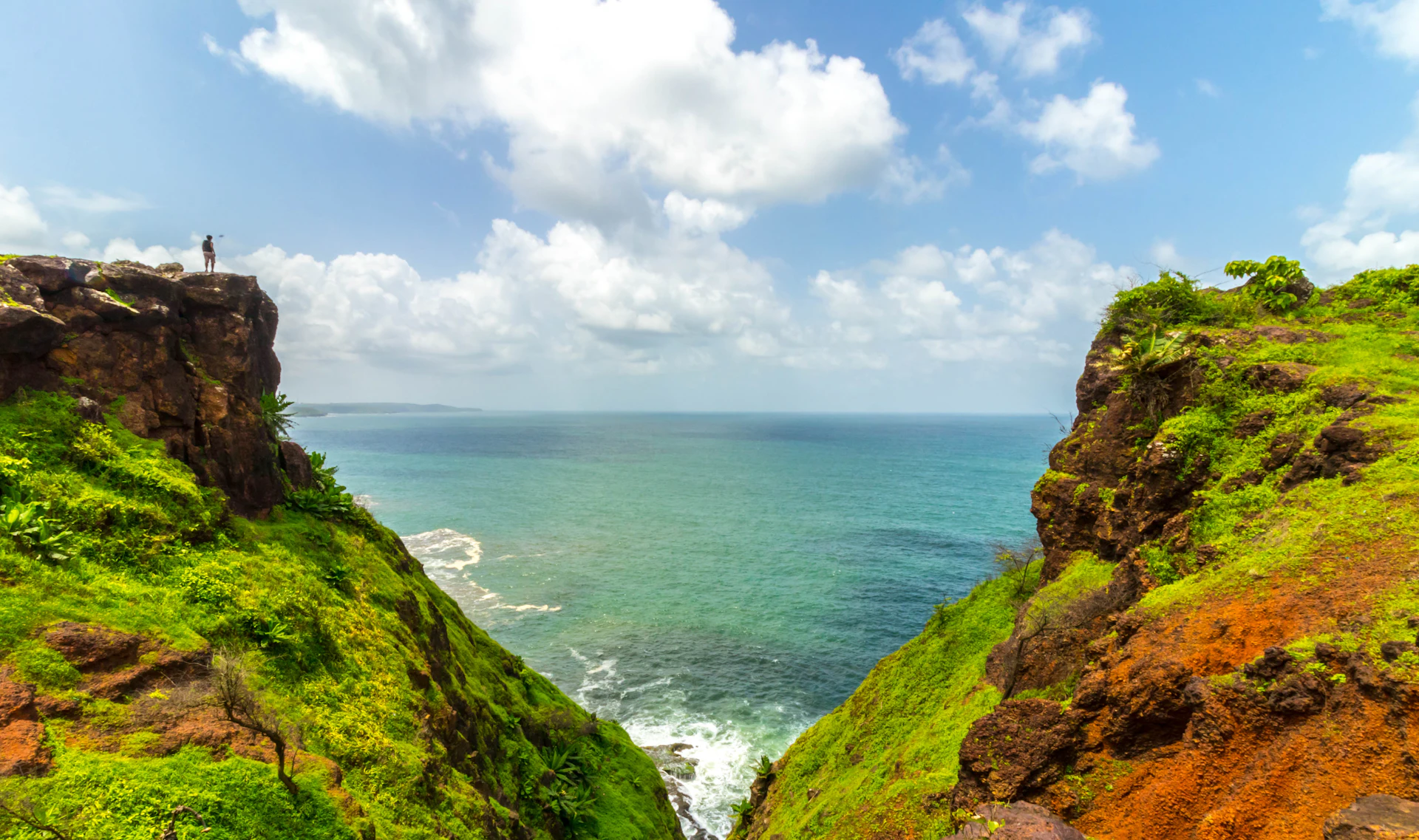 Traveller standing on a cliff above the Arabian Sea near Ratnagiri, Konkan