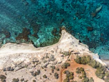 Aerial view of Costa Smeralda’s rugged coastline and sparkling sea.