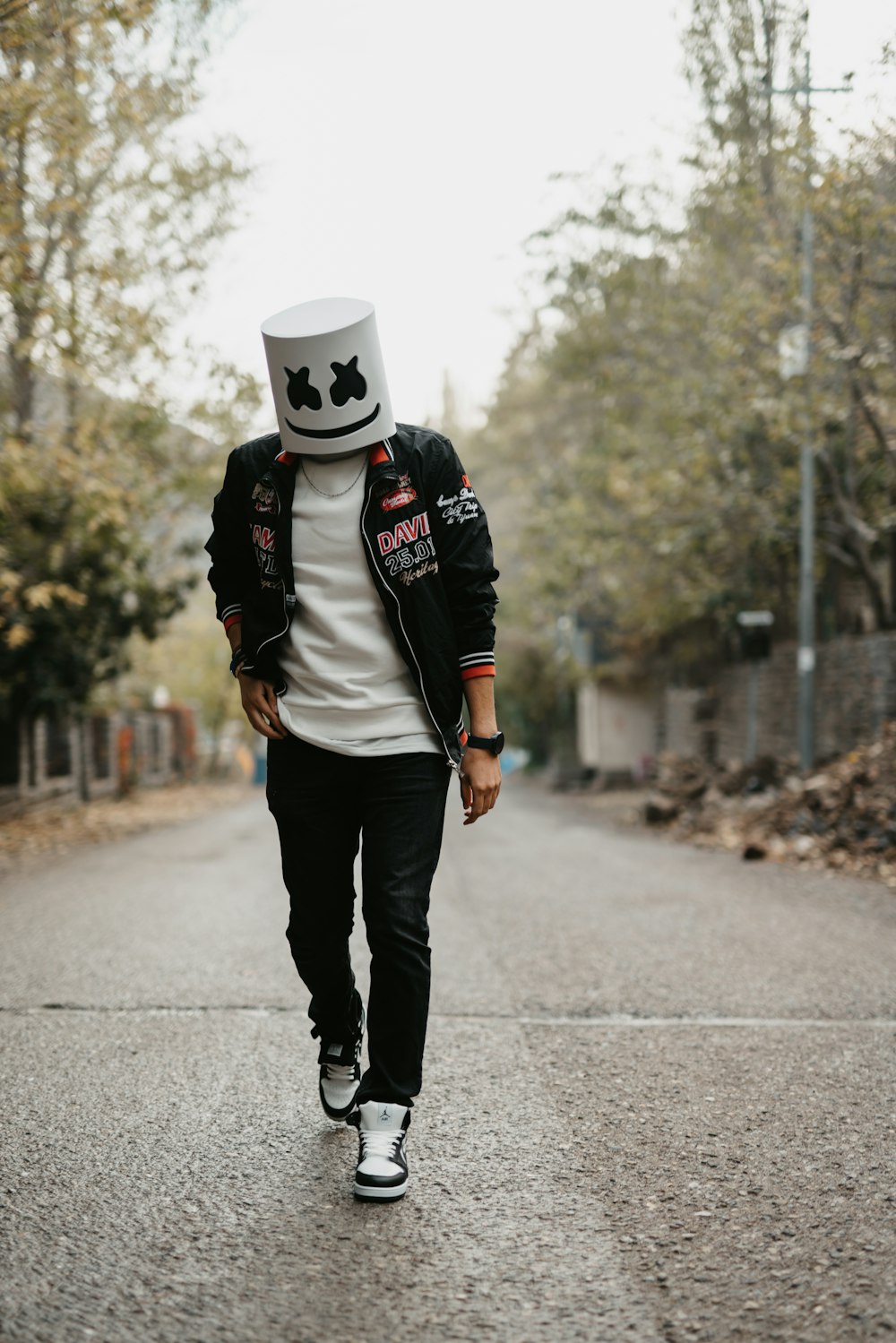 a man walking down a street wearing a hat