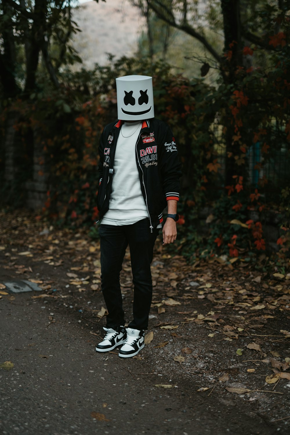 a man in a costume standing on a road