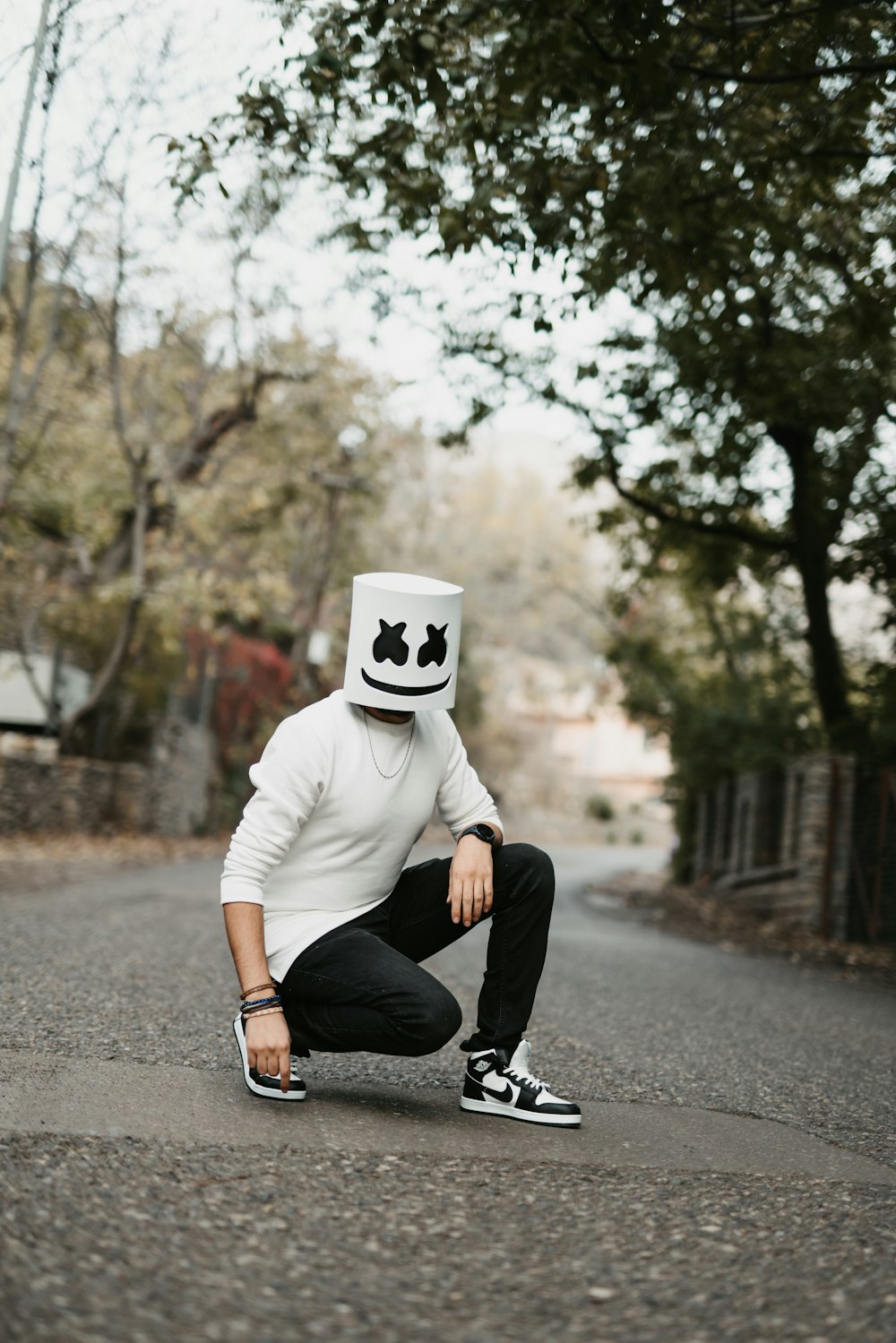 a man kneeling down on the side of a road