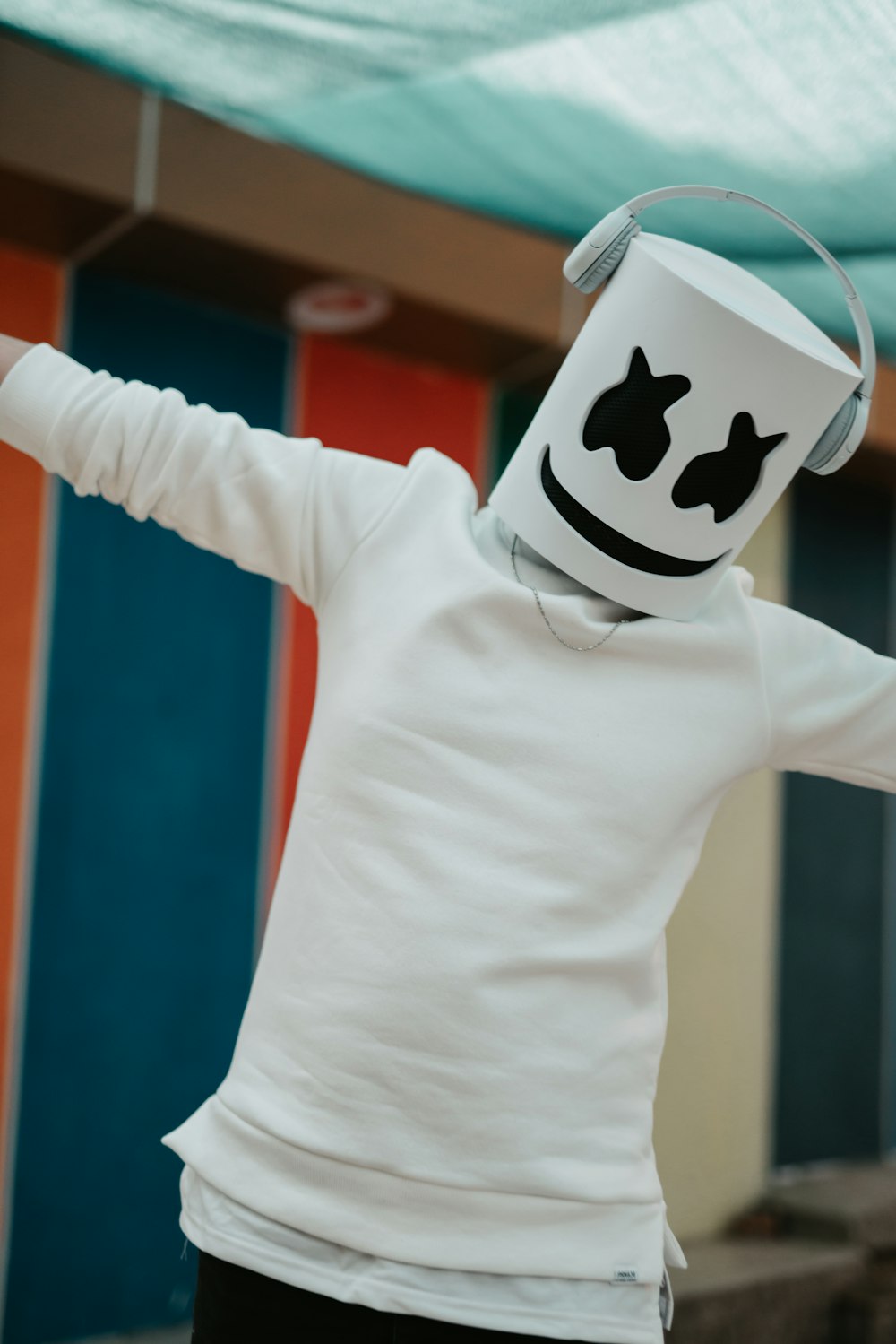 a person wearing a marshmallow mask and a white shirt