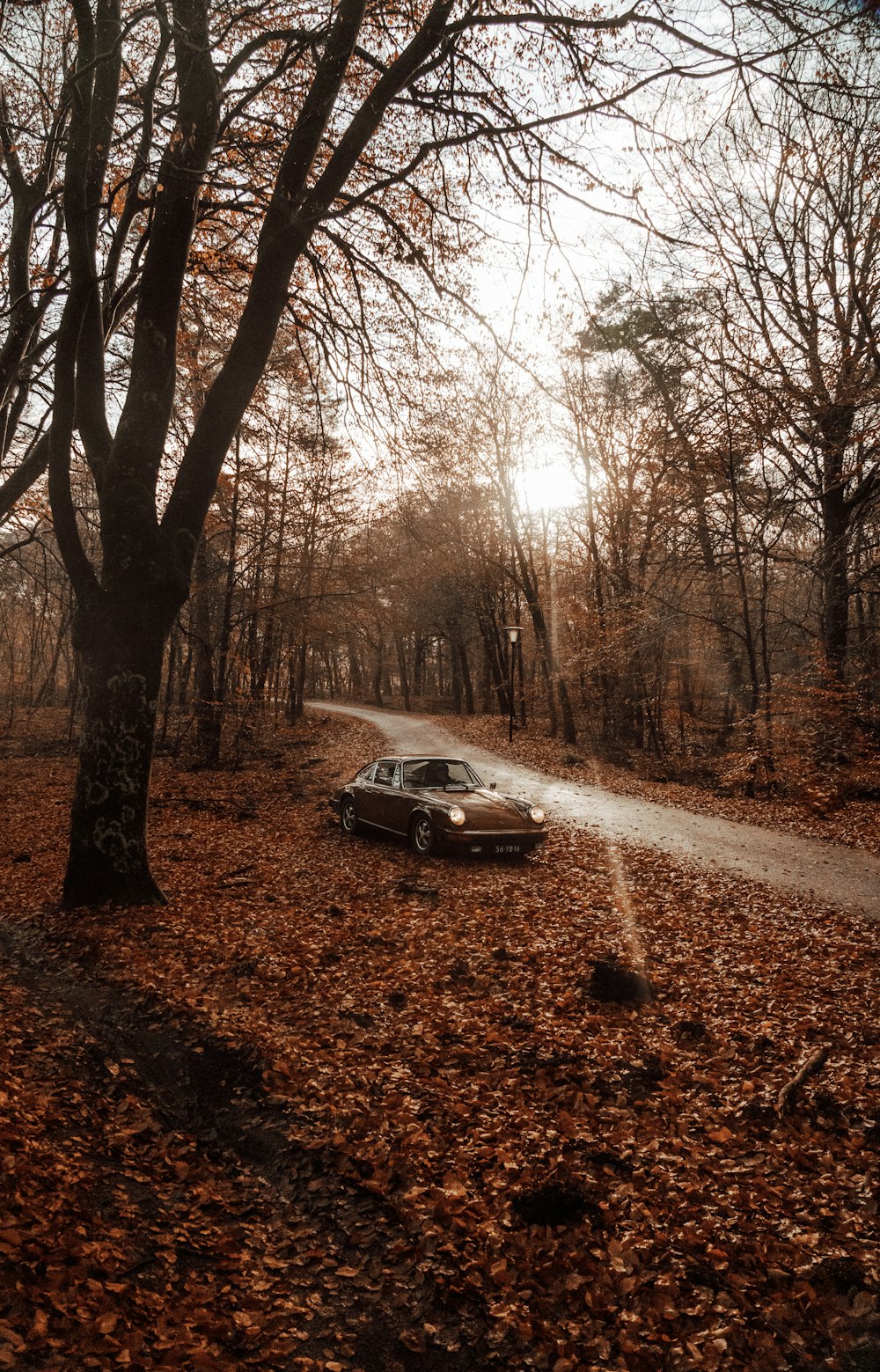 a car parked on the side of a dirt road