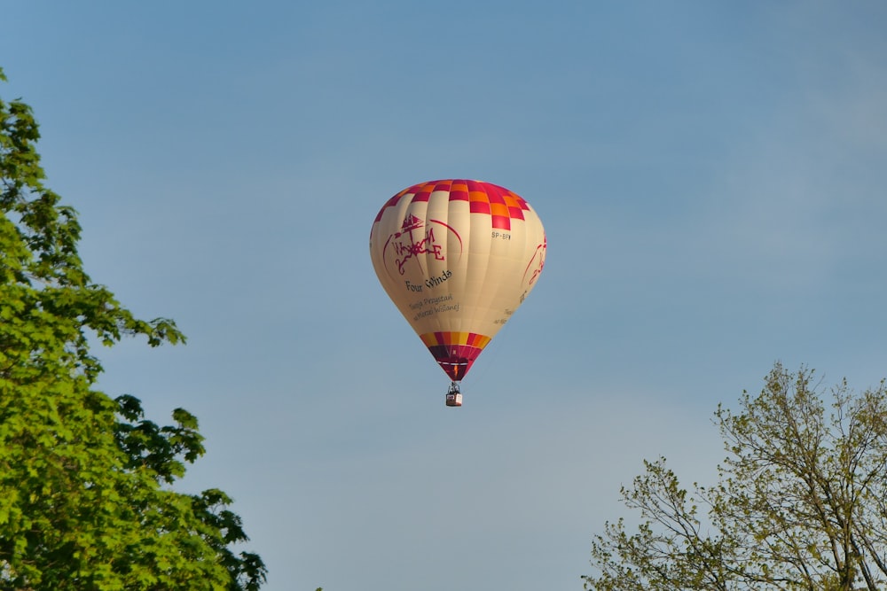 a hot air balloon flying through a blue sky