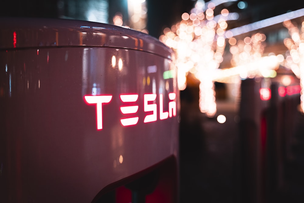 a close up of a tesla logo on the side of a car