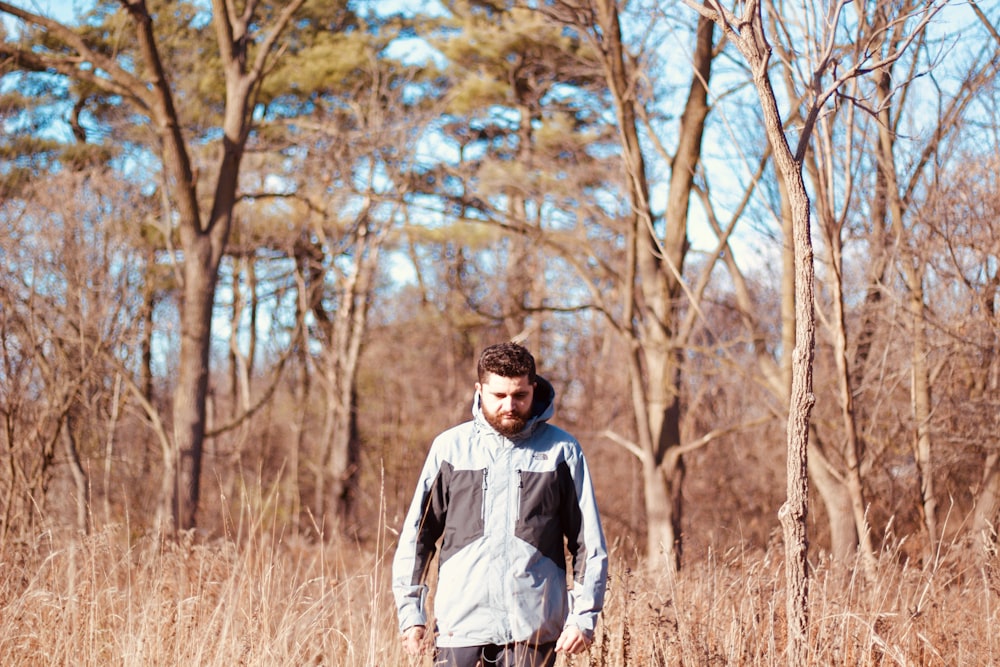 a man standing in a field with a frisbee