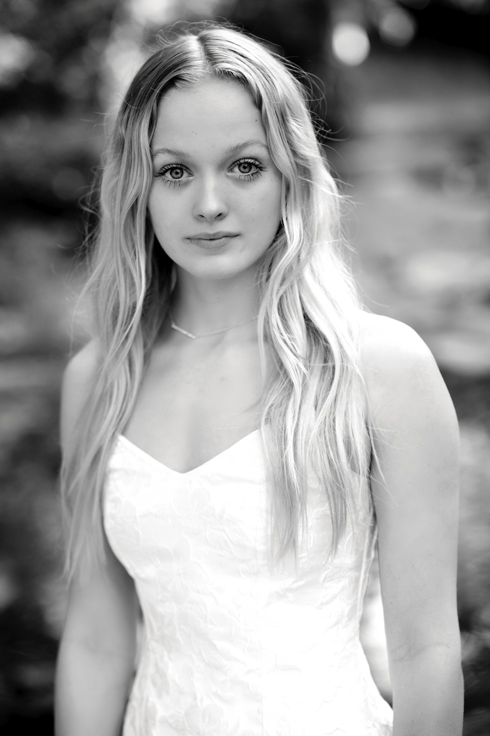 a woman in a white dress posing for a picture