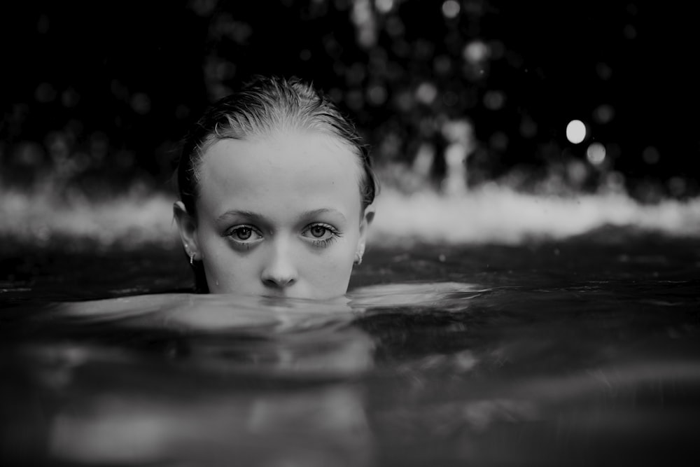 a woman swimming in a pool of water