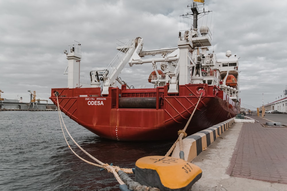 a large red boat docked at a dock