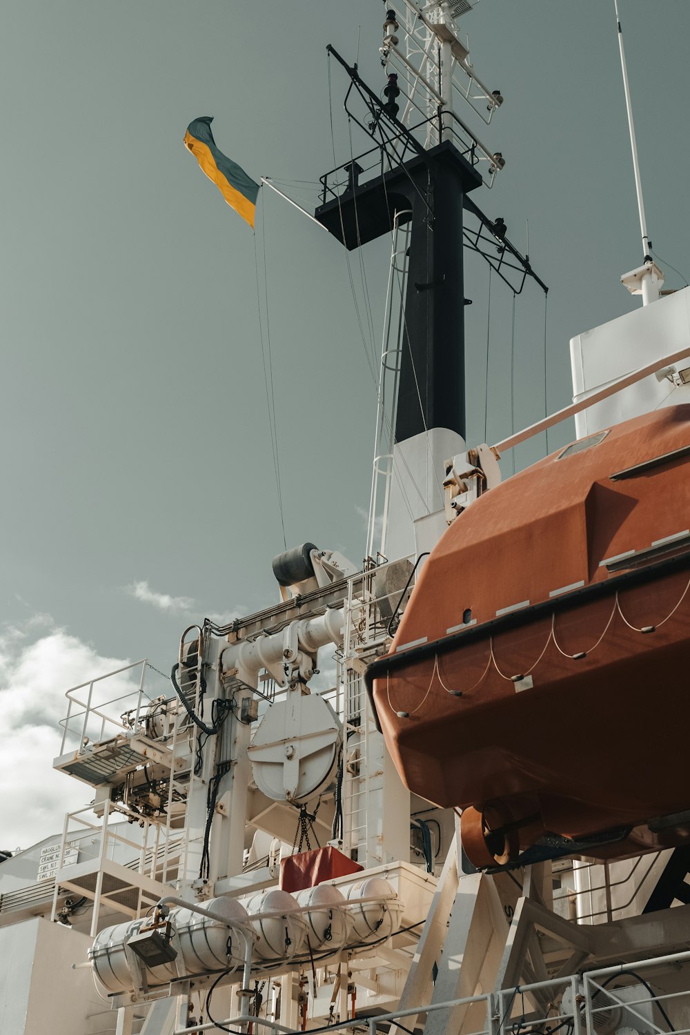 a large boat with a yellow flag on top of it